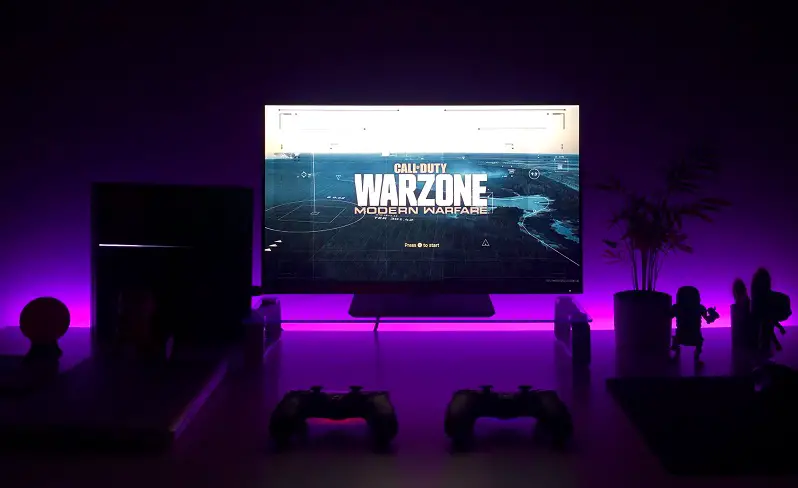 gaming on dark room with rgb light setup